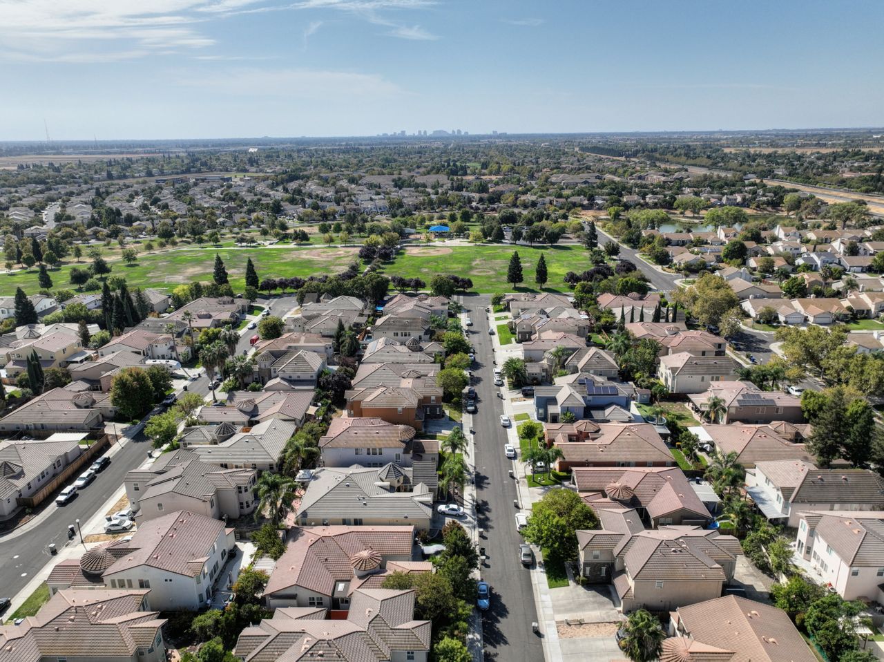 Aerial view of a California suburban neighbourhood, the kind of housing stock now being re-scored by wildfire risk models.