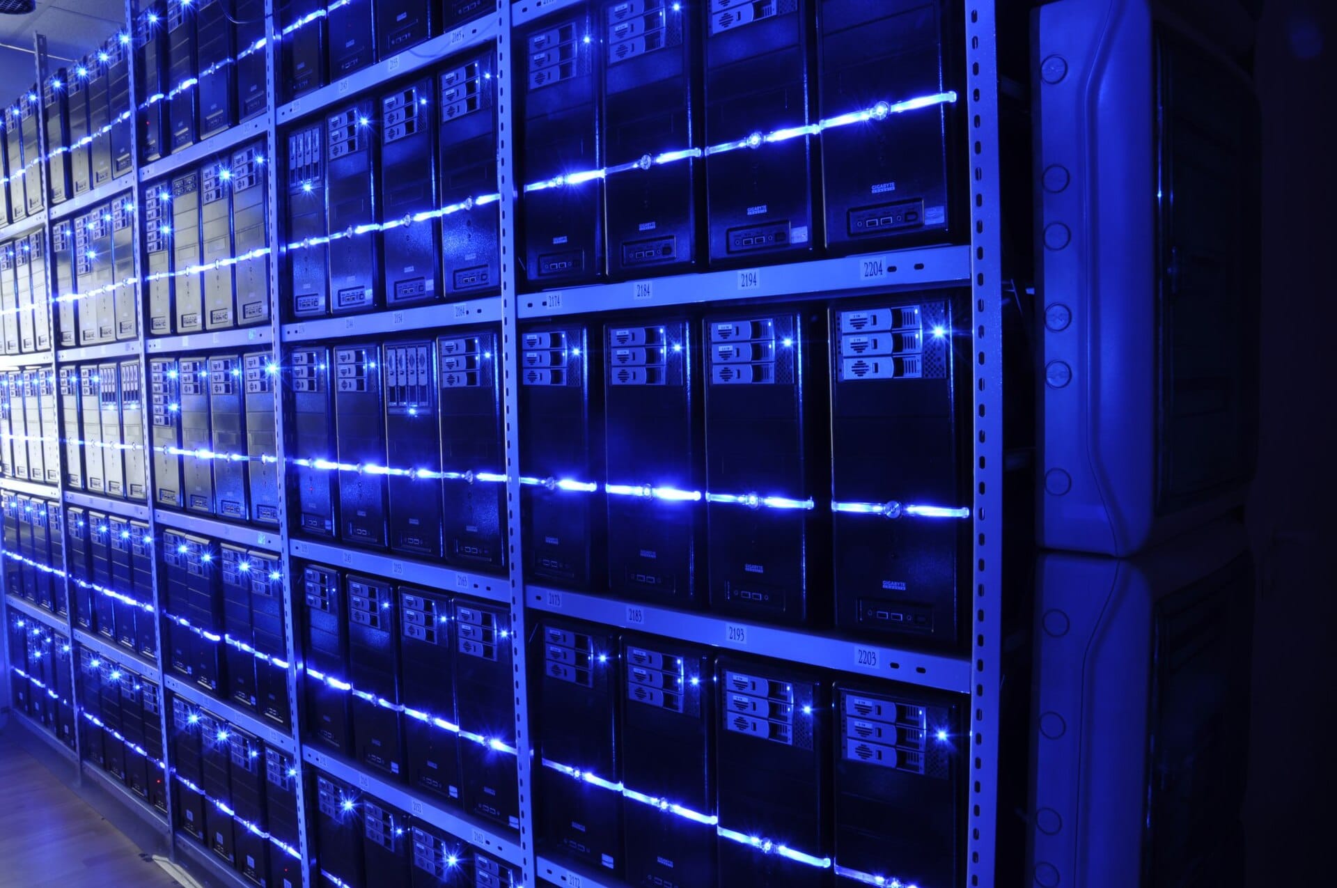 Rows of server racks in a data centre, the source of the AI memory demand crowding out consumer RAM supply.
